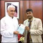 Salman Khurshid receiving a copy of the book edited by Rajiva Wijesinha