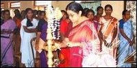Ms Subashini Chitravelu, legal advisor lighting the traditional oil lamp