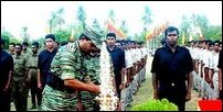 LTTEs Trincomalee military commander Vasanthan lighting the traditional oil lamp while the news recruits
