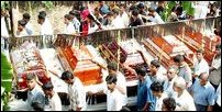 Bodies of five students being taken in a lorry along Main Street to Hindu Cemetery
