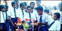 Students lit the traditional oil lamp.