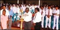 Mr.Thilakaretnam, Zonal Director is lighting the traditional oil lamp. Mr.Jegasothy, Attorney-at-Law and Mr.Sivanirthananda, Assistant Director of Education are seen (students in background).