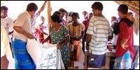 Resettled families collecting relief food materials
