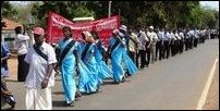 People in the demonstration march wearing black bands.