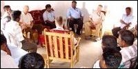 Villagers in discussion with SLMM head.
