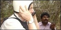 Mr.Henricsson on satellite phone inside bunker with Mr.Elilan during artillery fire iat Maavil Aaru.