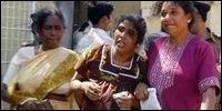 Relatives react after identifying the bodies of slain workers from the international aid agency Action Contre La Faim (ACF), at a hospital entrance in Trincomalee, August 8, 2006. (REUTERS)