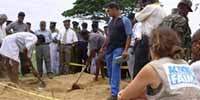 Representatives of international relief agency Action Against Hunger, right, look on as workers exhume the remains of one of 17 aid workers. (Photo:AP)