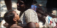 A wounded mother is struggling with her child.