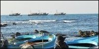 Indian trawlers held by Eezham Tamil fishermen in the seas off Point Pedro and Indian fishermen being brought to the shores in small boats